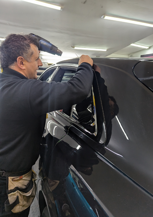 TJ Mods wrapping a car at the Ilford workshop